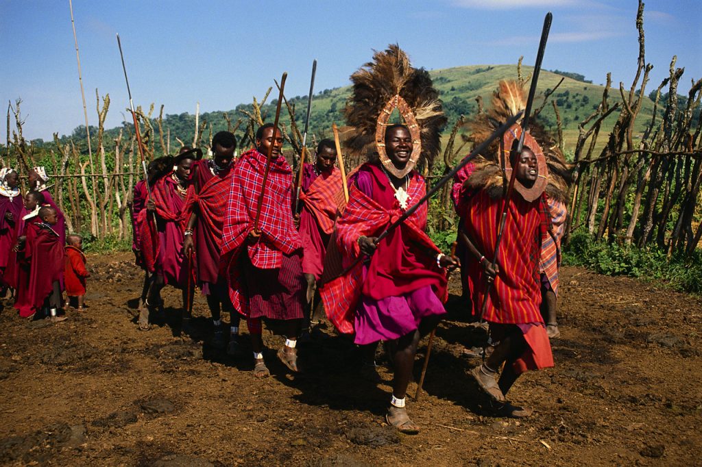 A group of Masai men perform a traditional dance in their village. Tanzania